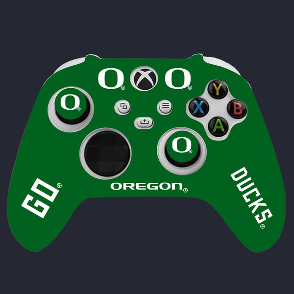 Green gaming controller with 'Oregon Ducks' branding on a dark background